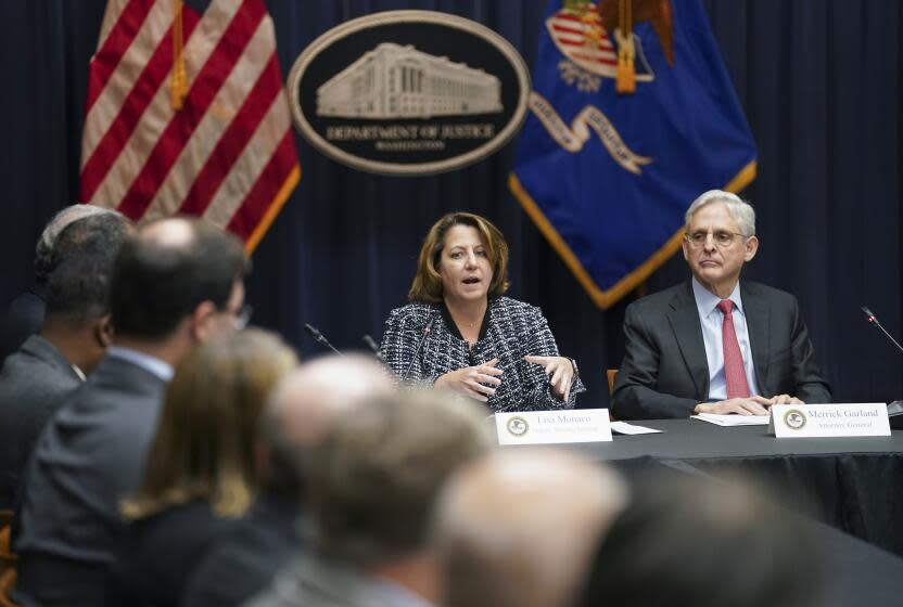 U.S. Attorney General Merrick Garland and Deputy U.S. Attorney General Lisa Monaco convene the coronavirus disease fraud enforcement task force at the Justice Department in Washington, Thursday, March 10, 2022. (Kevin Lamarque/Pool via AP)