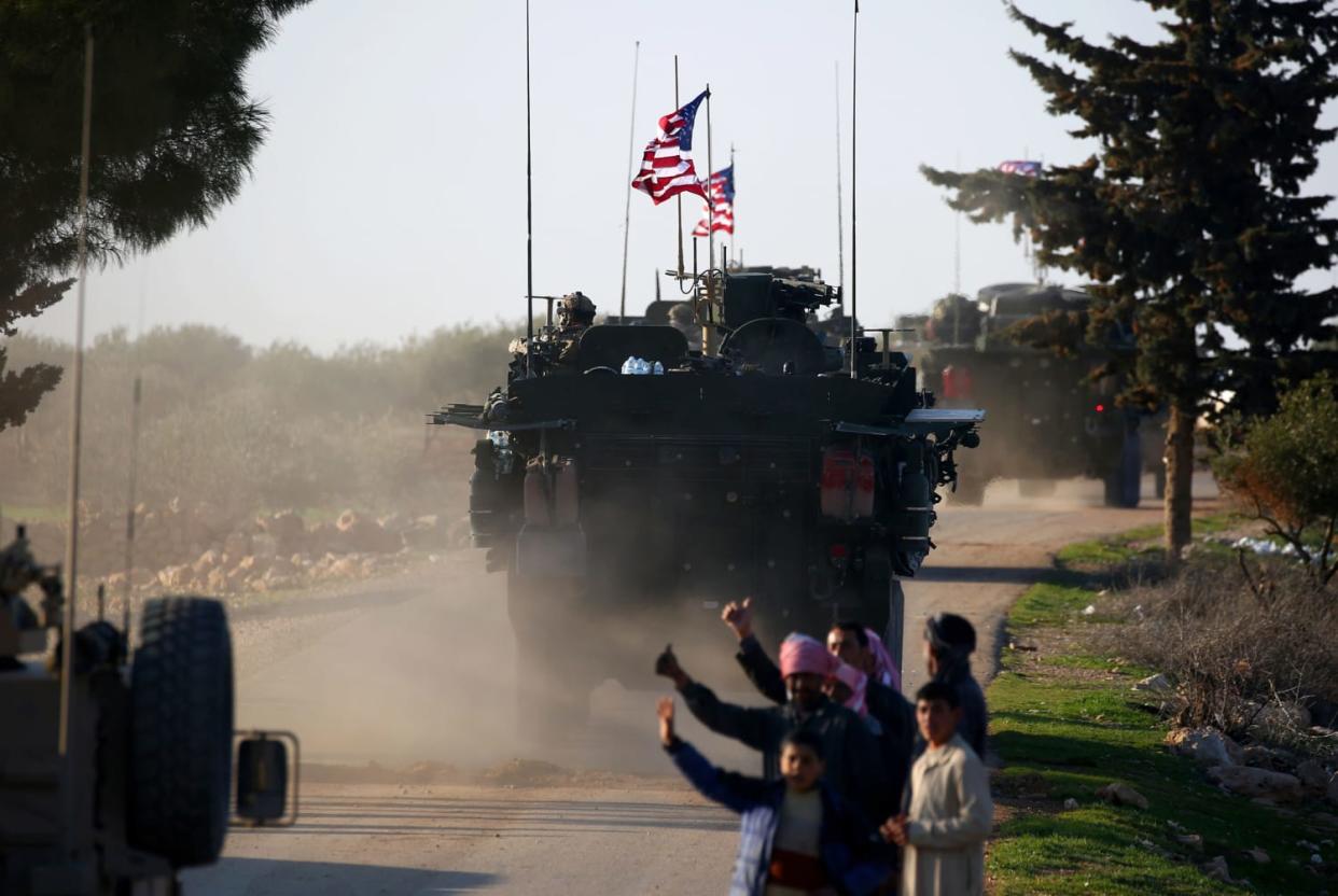 Image: A U.S. armored vehicles convoy drive near the village of Yalanli, Syria, on March 5, 2017.