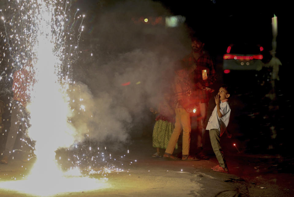 Children play with firecrackers during Diwali celebrations in Hyderabad, India, Thursday, Nov. 4, 2021. Millions of people across Asia are celebrating the Hindu festival of Diwali, which symbolizes new beginnings and the triumph of good over evil and light over darkness. Diwali, the festival of lights, is one of Hinduism's most important festivals dedicated to the worship of Lakshmi, the Hindu goddess of wealth. (AP Photo/Mahesh Kumar A.)