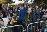 People pray as they wait for Pope Francis to arrive to celebrate a Mass in Confluence Park in Kaunas, Lithuania, Sunday, Sept. 23, 2018. Pope Francis is on the second of his two-day visit to Lithuania. (AP Photo/Mindaugas Kulbis)