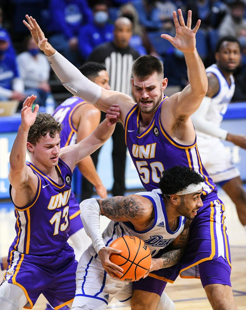 Northern Iowa guard Bowen Born (13) and forward Austin Phyfe (50) trap Drake guard Roman Penn during their Feb. 5 game in Des Moines.