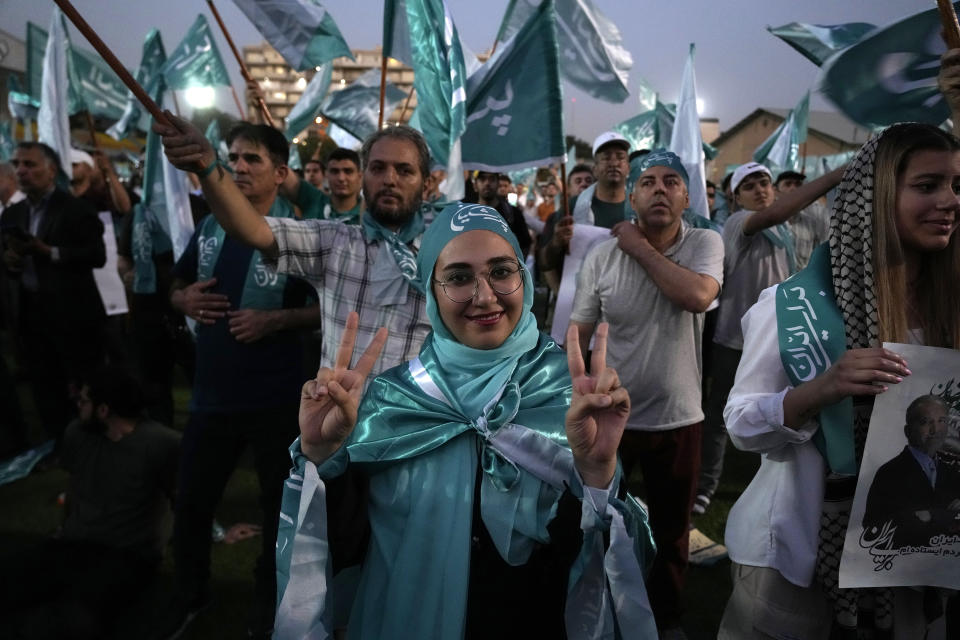 A supporter of the reformist candidate for the Iran's presidential election Masoud Pezeshkian flashes the victory sign during a campaign rally in Tehran, Iran, Wednesday, July 3, 2024. Comments suggesting that Iran's reformist presidential candidate could increase government-set gasoline prices have raised fears of a repeat of nationwide protests. (AP Photo/Vahid Salemi)