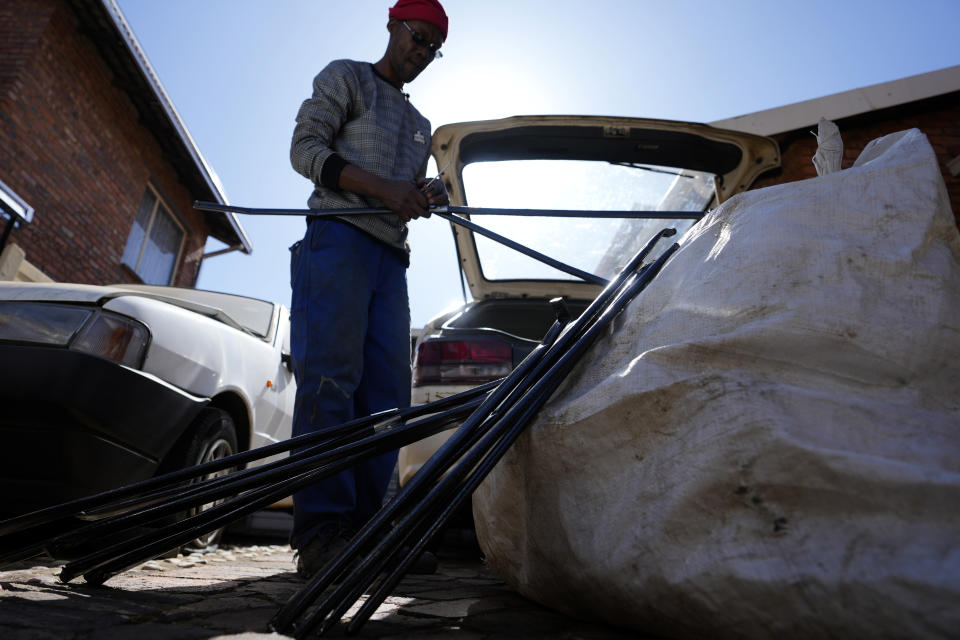 Themba Khumalo collects empty metal and plastic containers to sell and support his family in Daveyton township, east of Johannesburg, South Africa, Tuesday, Aug. 1, 2023. South Africa's official unemployment rate of 33% is the highest in the world, and economists say it's even higher at 42% if you count those who have given up looking for work and have dropped off unemployment systems. (AP Photo/Themba Hadebe)