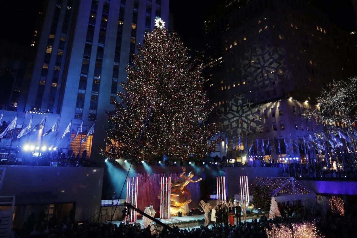 Festive: The Rockefeller Center Christmas tree lit up at the 85th annual ceremony: EPA