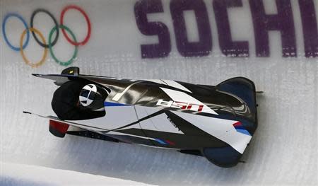 Two-man bobsleigh pilot Cory Butner of the U.S. speeds down the track during a training session of the Sochi 2014 Winter Olympic Games at the Sanki sliding center in Rosa Khutor, February 13, 2014. REUTERS/Arnd Wiegmann