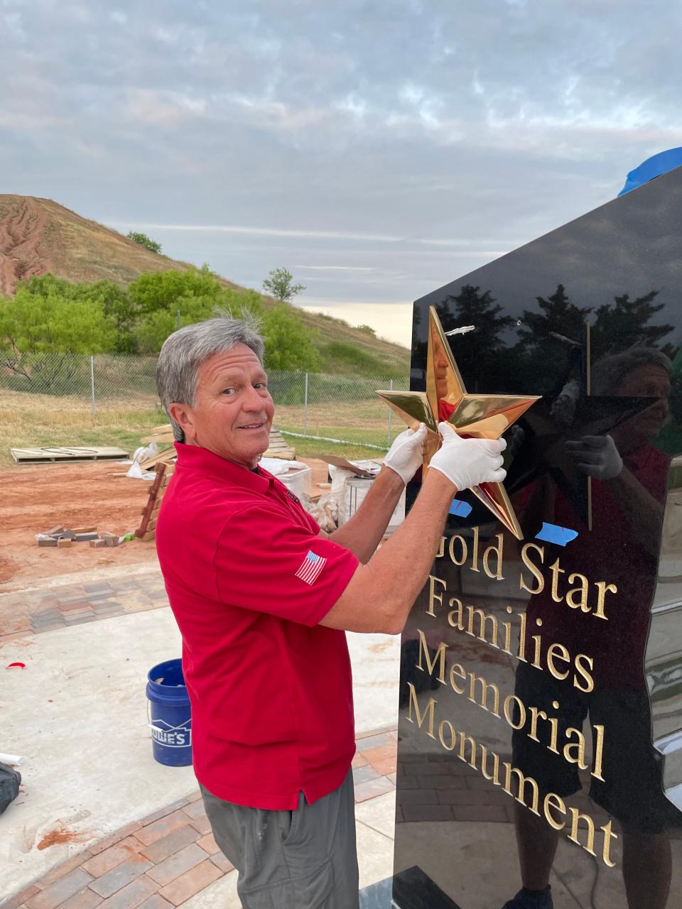 David Coleman, chairman of the Lake Wichita Revitalization Committee, hangs the star on the Gold Star Families monument at the veterans memorial at Lake Wichita.