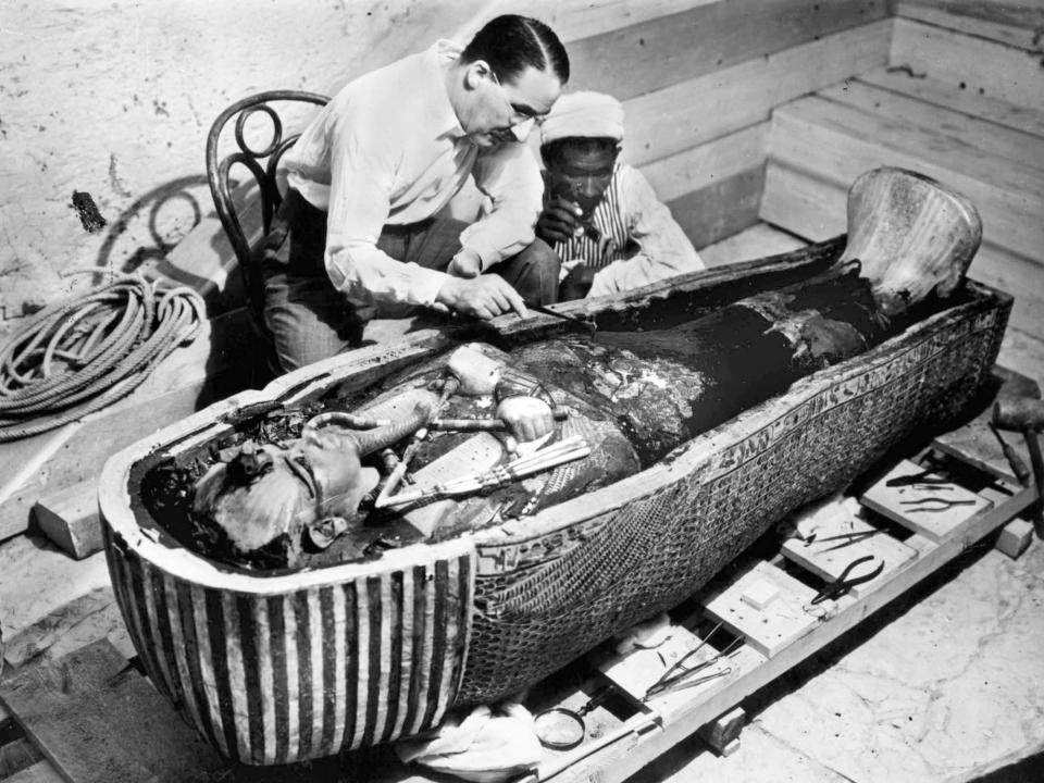 The sarcophagus of King Tutankhamun in 1922. The photo also shows Egyptologist Howard Carter, left, with an unidentified man.