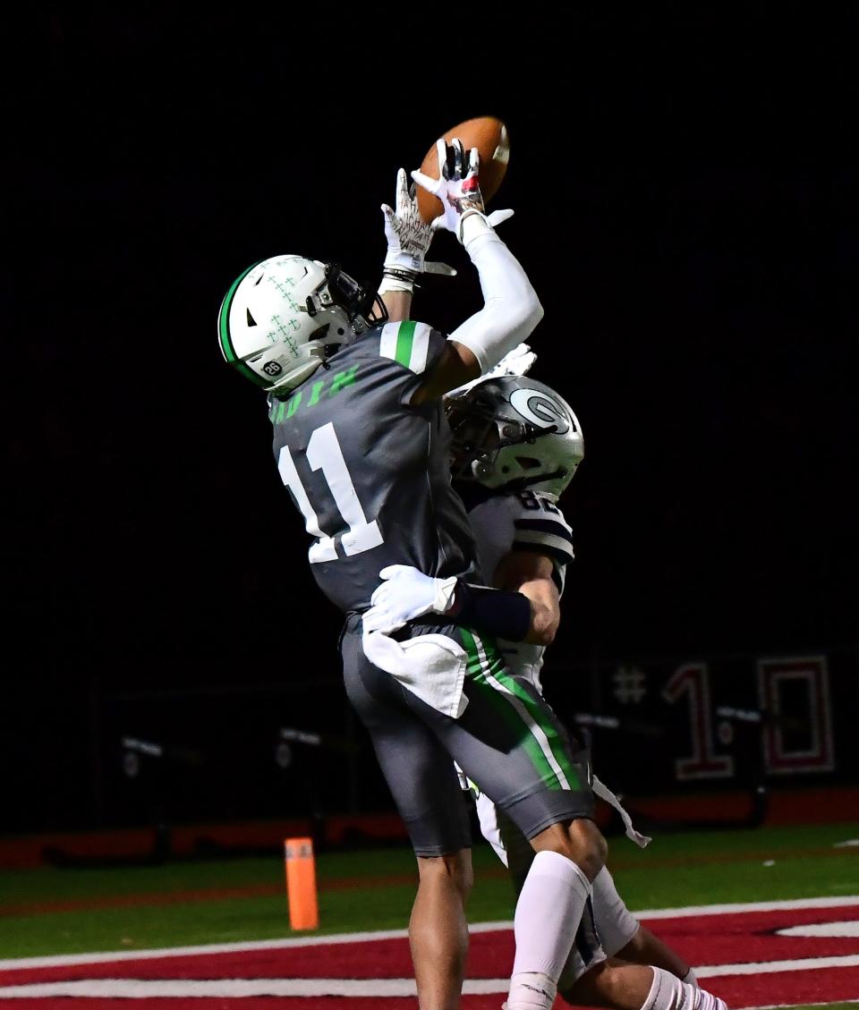 Braedyn Moore (11) hauls in a long pass for a Badin catch inside the five-yard line setting up the Rams' first touchdown of the night at the OHSAA Division III state football semifinals, Nov. 26, 2021.