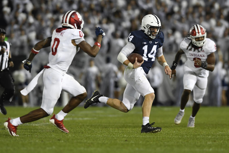 Penn State quarterback Sean Clifford (14) scrambles as Indiana defensive back Raheem Layne II (0) chases him in the second half of their NCAA college football game in State College, Pa., on Saturday, Oct. 2, 2021. Penn State defeated Indiana 24-0. (AP Photo/Barry Reeger)