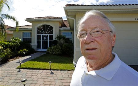 Robert Davidson stands in front of the home he purchased in 2011 in a Naples, Florida golf course community September 21, 2013. REUTERS/Joe Skipper