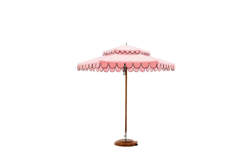 pink outdoor umbrella with scalloped edges trimmed in a darker color