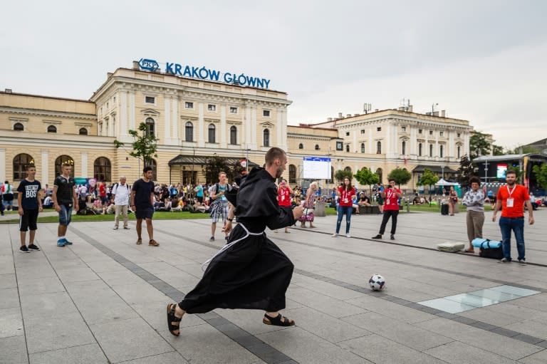 Young people and a monk play football in Krakow, Poland, on July 25, 2016, one day ahead of the opening of the World Youth Day to be attended by Pope Francis