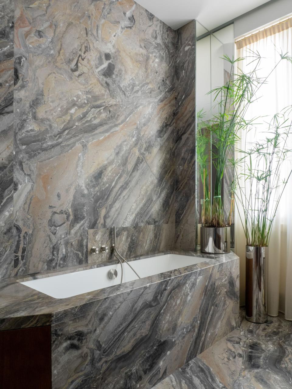 Inspired by Villa Necchi, Werz lined the bathroom in graphic gray marble.