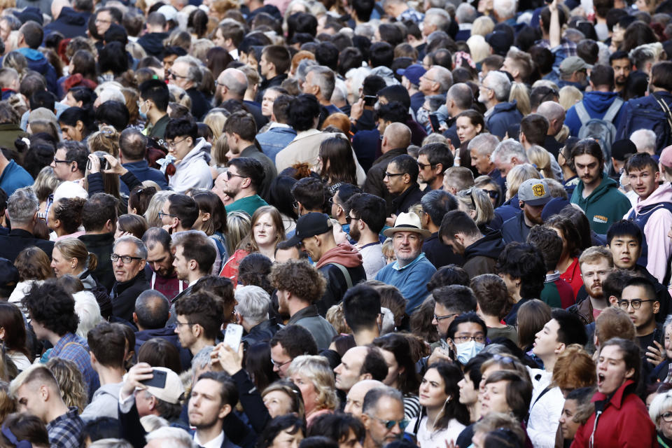 <p>Crowds gather near Mercat Cross for the procession of Her Majesty The Queen Elizabeth II's Coffin To St Giles Cathedral on September 12, 2022 in Edinburgh, Scotland. (Photo by Jeff J Mitchell/Getty Images)</p> 