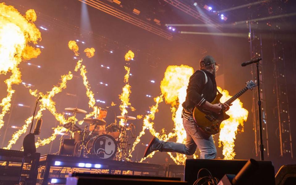 Fall Out Boy guitarist and vocalist Patrick Stump dances while pyrotechnics surround drummer Andy Hurley during the groups concert on Sunday at Golden 1 Center.