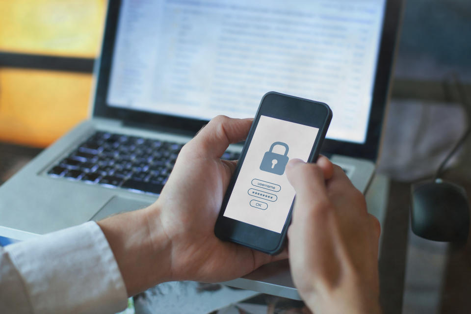 A man accessing his account on his phone. (PHOTO: Getty Images)