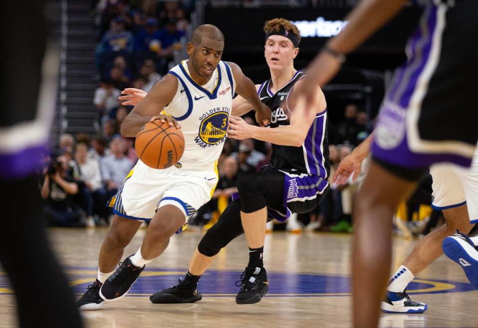 Golden State Warriors guard Chris Paul (3) drives past Sacramento Kings guard Kevin Huerter (9) during the third quarter of a preseason game Oct. 18, 2023, at Chase Center in San Francisco.