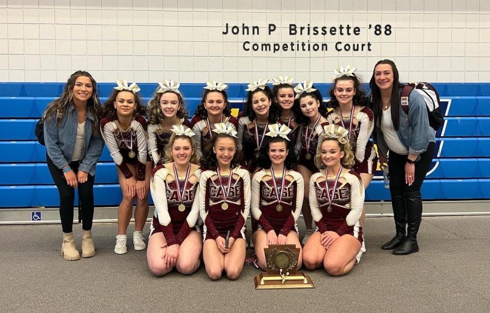 Members of the Joseph Case cheerleading squad with coaches Ashley and Lauren Mello after winning New Englands.