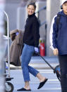 <p>A smiling Katie Holmes totes her suitcase on Friday in New York City.</p>