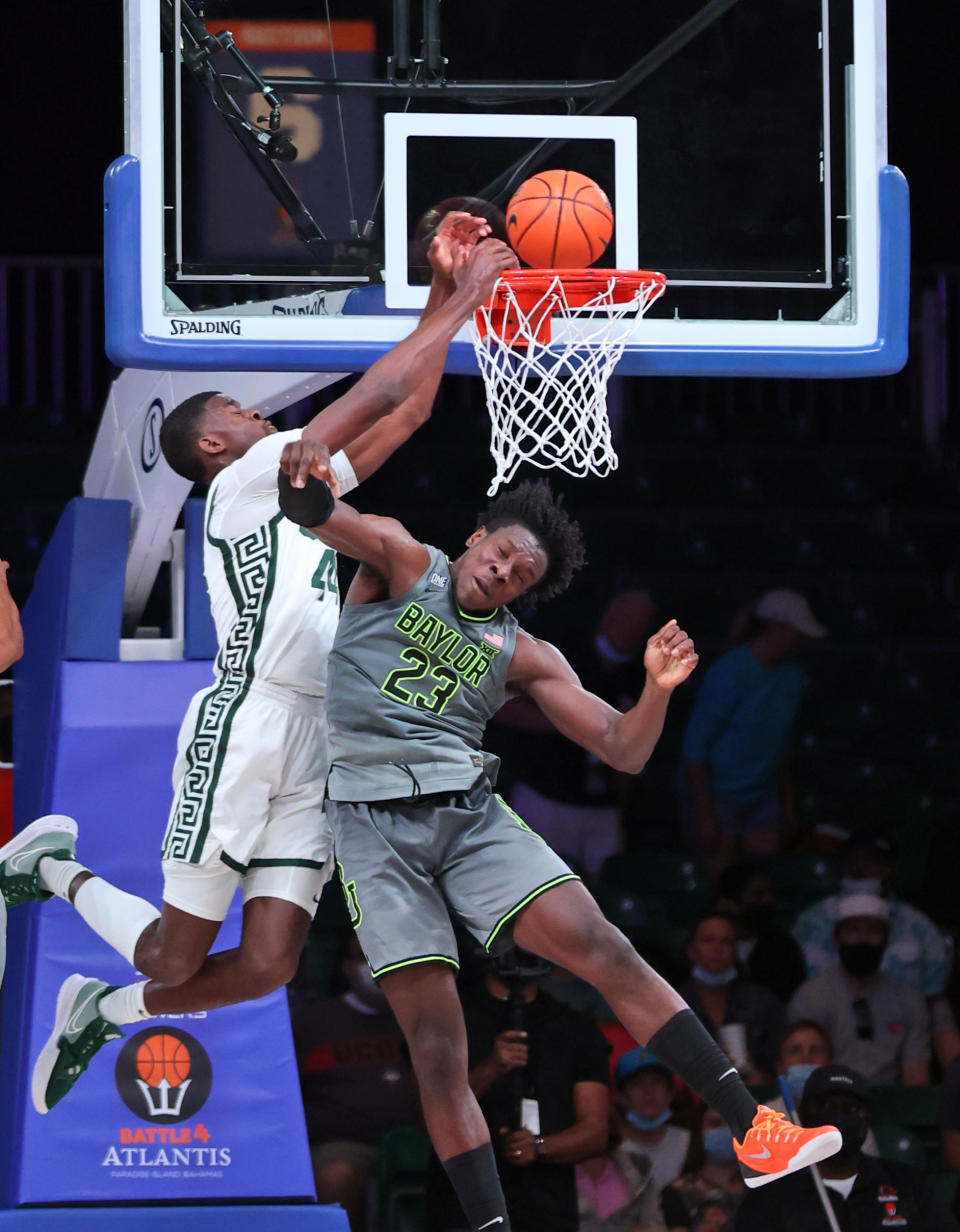 In this photo provided by Bahamas Visual Services, Michigan State forward Gabe Brown (44) goes to the basket as Baylor forward Jonathan Tchamwa Tchatchoua (23) defends during an NCAA college basketball game at Paradise Island, Bahamas, Friday, Nov. 26, 2021. (Tim Aylen/Bahamas Visual Services via AP)