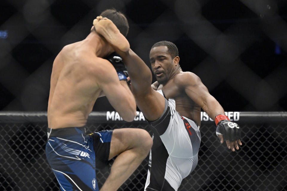 Geoff Neal, right, connects with a kick to Shavkat Rakhmonov during a UFC 285 mixed martial arts welterweight bout Saturday, March 4, 2023, in Las Vegas. (AP Photo/David Becker) ORG XMIT: NVDB115