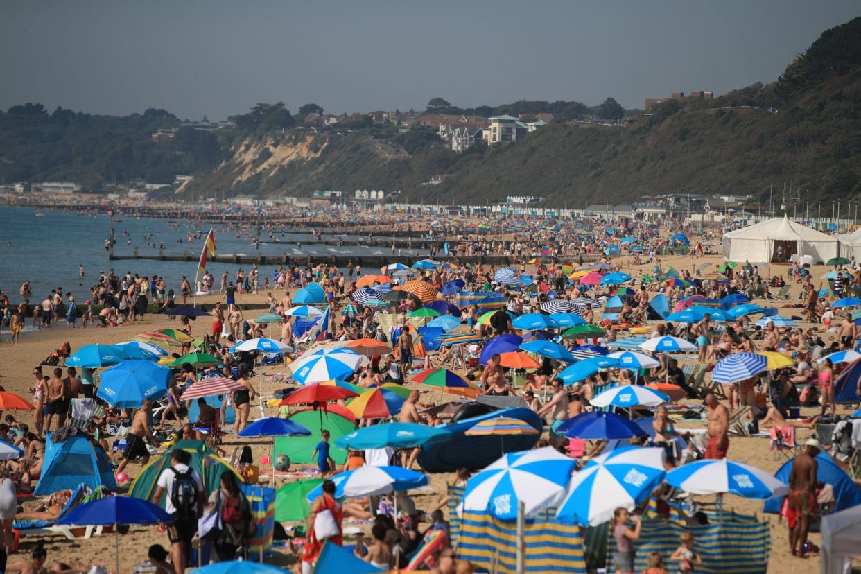 People on Bournemouth Beach enjoy the sunshine on Sunday as temperatures reached record highs for an August bank holiday weekend: Adam Davy/PA