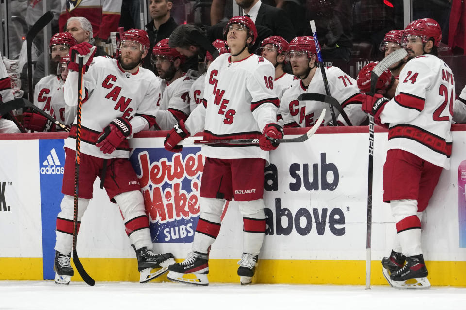 Carolina Hurricanes left wing Jordan Martinook, left, left wing Teuvo Teravainen (86) and center Seth Jarvis (24) watch a replay review during the third period of Game 3 of the NHL hockey Stanley Cup Eastern Conference finals against the Florida Panthers, Monday, May 22, 2023, in Sunrise, Fla. (AP Photo/Lynne Sladky)