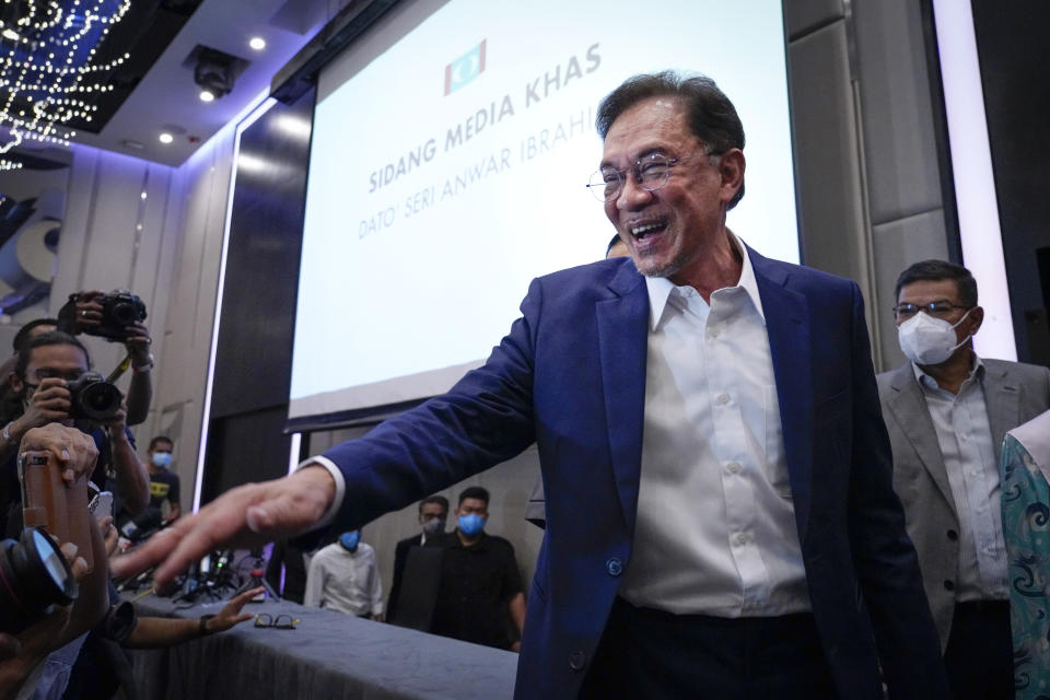 Malaysia's opposition leader Anwar Ibrahim gestures as he leaves after a press conference in Kuala Lumpur, Wednesday, Sept. 23, 2020. Anwar said he has secured a majority in parliament to form a new government that is “strong, stable and formidable." (AP Photo/Vincent Thian)