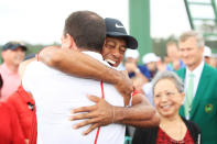 Tiger Woods of the United States embraces his manager Mark Steinberg as he comes off the 18th hole in celebration of his win during the final round of the Masters at Augusta National Golf Club on April 14, 2019 in Augusta, Georgia. (Photo by Andrew Redington/Getty Images)