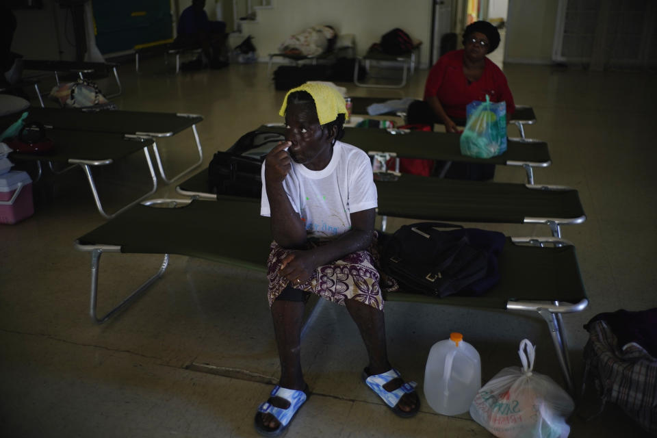 Women sit on cots inside a church now serving as a shelter for residents who will wait out Hurricane Dorian in Freeport on Grand Bahama, Bahamas, Sunday, Sept. 1, 2019. Hurricane Dorian intensified yet again Sunday as it closed in on the northern Bahamas, threatening to batter islands with Category 5-strength winds, pounding waves and torrential rain. (AP Photo/Ramon Espinosa)