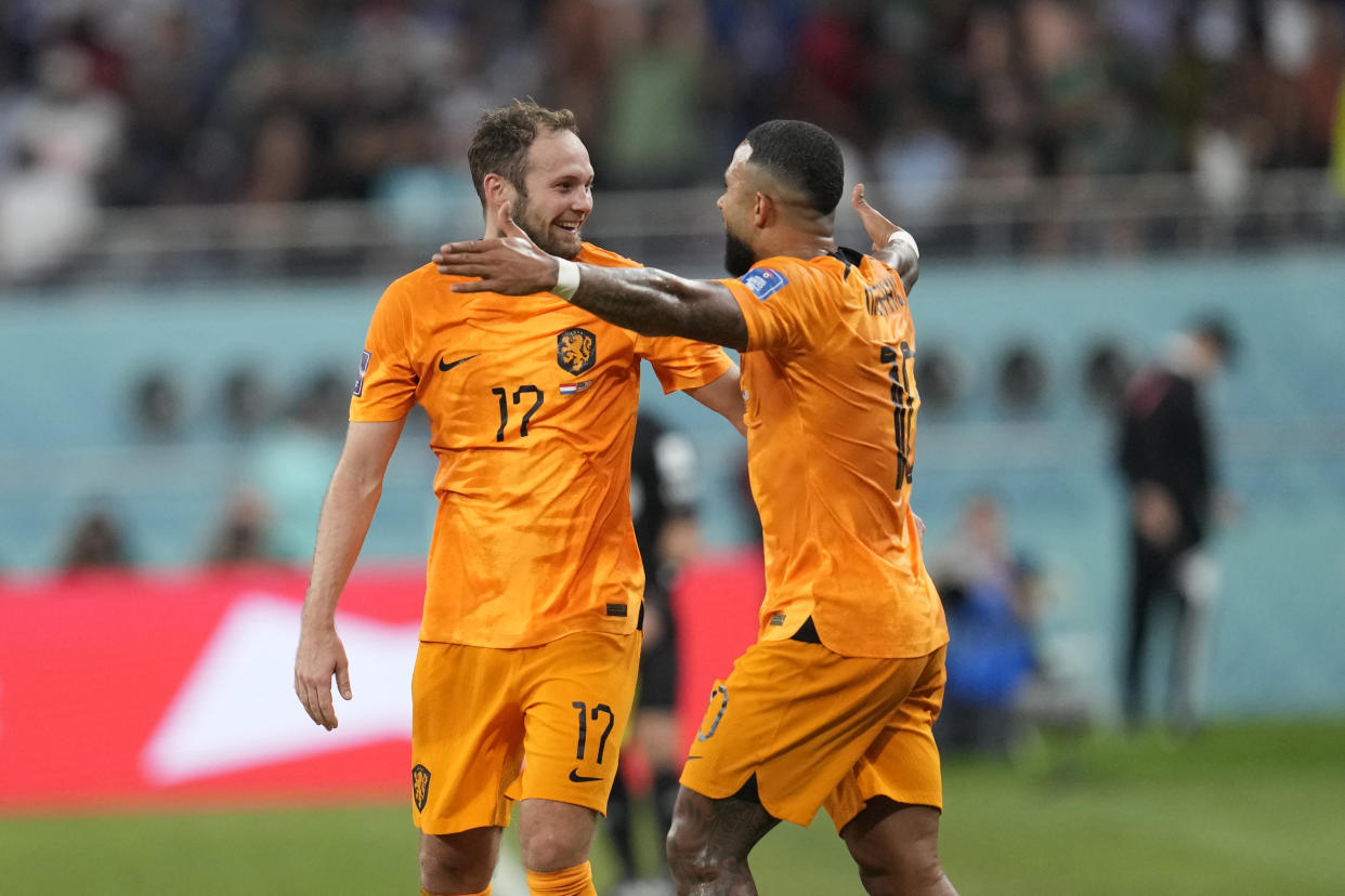 Daley Blind of the Netherlands celebrates after scoring his side's second goal with Memphis Depay of the Netherlands during the World Cup round of 16 soccer match between the Netherlands and the United States, at the Khalifa International Stadium in Doha, Qatar, Saturday, Dec. 3, 2022. (AP Photo/Natacha Pisarenko)
