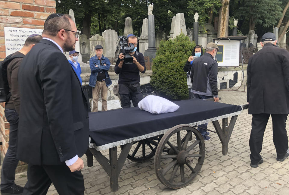 Warsaw's Jewish community held a funeral for an unidentified Holocaust victim after human remains were recently discovered in an area that belonged to the Warsaw Ghetto during World War II, in Warsaw, Poland, Tuesday Sept. 14, 2021. The remains were buried in Warsaw's Jewish Cemetery, with the country's chief rabbi saying, "We are here as the family for a person we don't know." (AP Photo/Vanessa Gera)
