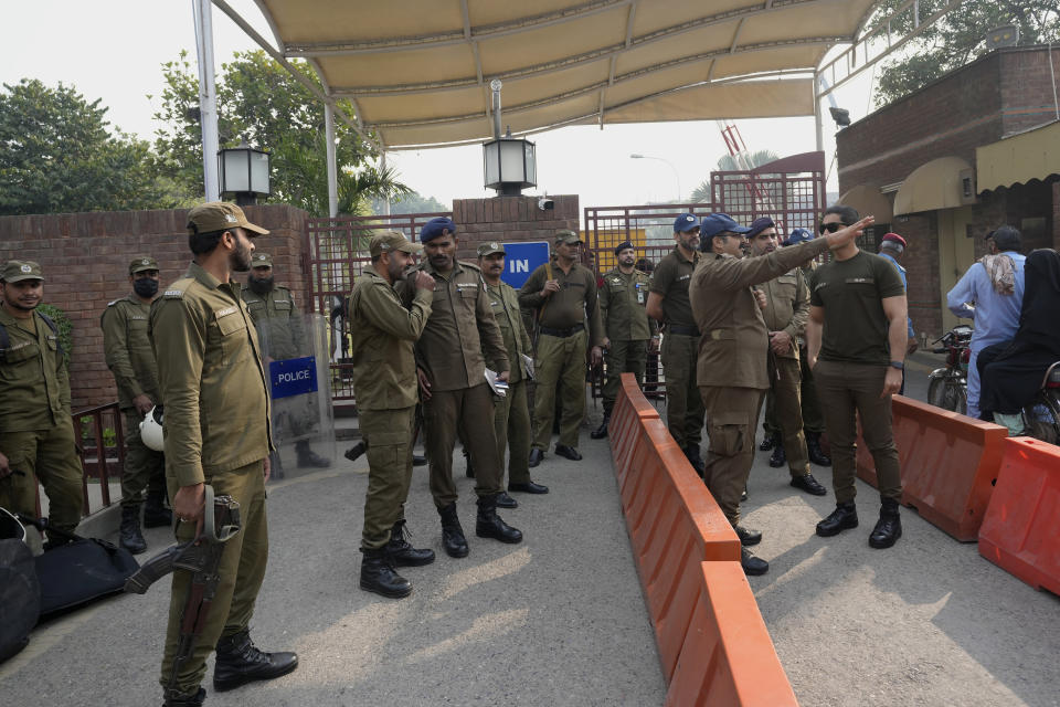 Police officers stand guard outside a hospital where former Pakistani Prime Minister Imran Khan is being treated in Lahore, Pakistan, Friday, Nov. 4, 2022. Khan, who narrowly escaped an assassination attempt on his life the previous day when a gunman fired multiple shots wounding him in the leg, is listed in stable condition after undergoing surgery at a hospital, a senior leader from his party said Friday. (AP Photo/K.M. Chaudhry)