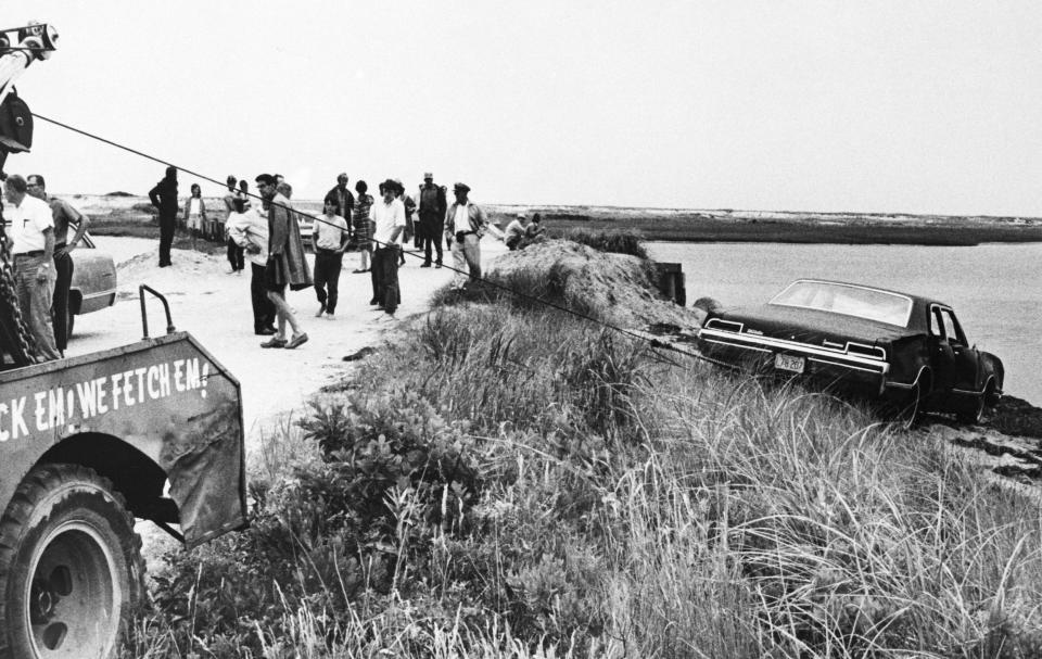 A tow truck pulls Senator Edward Kennedy's car out of Poucha Pond after the Senator's infamous accident on Chappaquiddick Island in 1969.