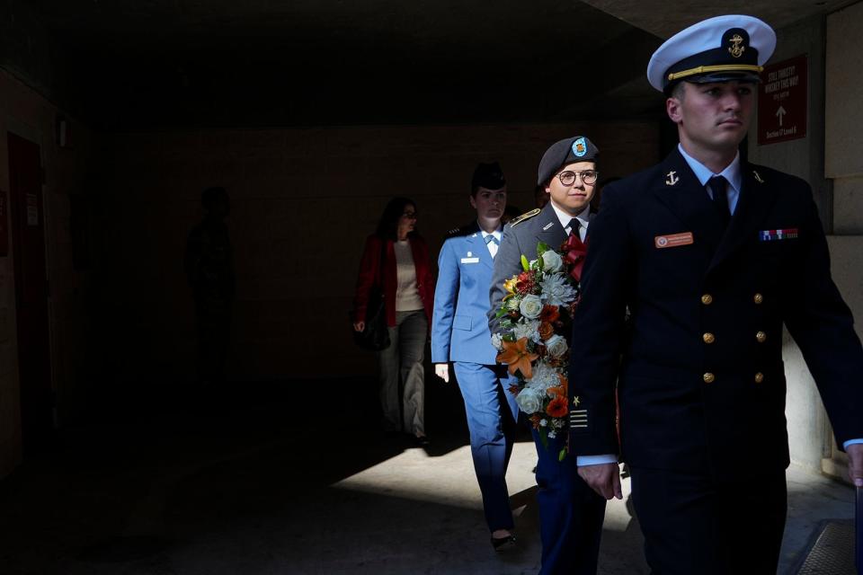 The wreath is transported to the Frank Denius Veterans Memorial Plaza by ROTC members Braxton Robison, front, Map Pesqueira, middle, and Regan Chicoria for UT's annual wreath-laying ceremony Thursday.