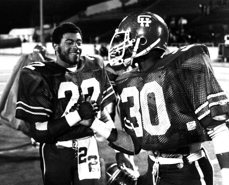 John Wooldridge shakes the hand of a Central-Hower football teammate in an undated photo.