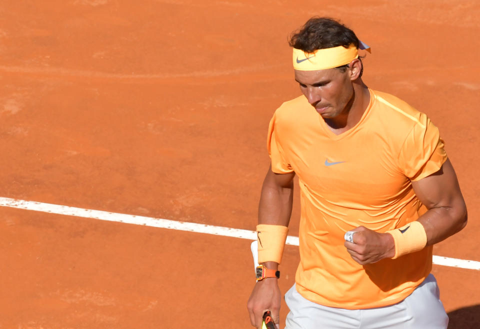 Rafa Nadal fist-pumps and celebrates reacts a point.