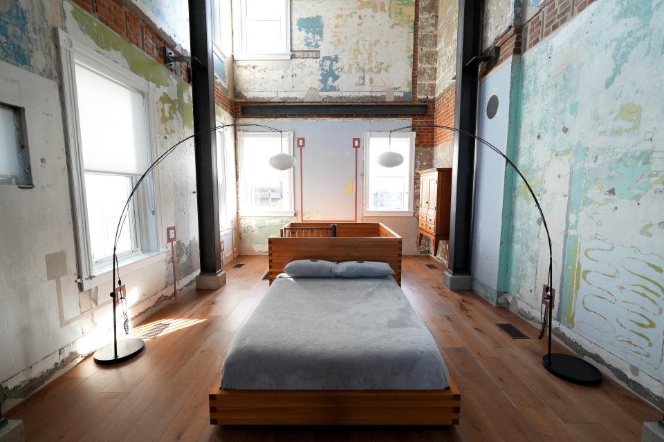 View of the bed in an Airbnb rental property known as the Swing House, featuring a large swing hung from the ceiling, in the industrial neighborhood of Camp Washington in Cincinnati, pictured, Thursday, Dec. 2, 2021. The Italianate, three-story home built in 1880 has been converted into one massive, wide-open room.