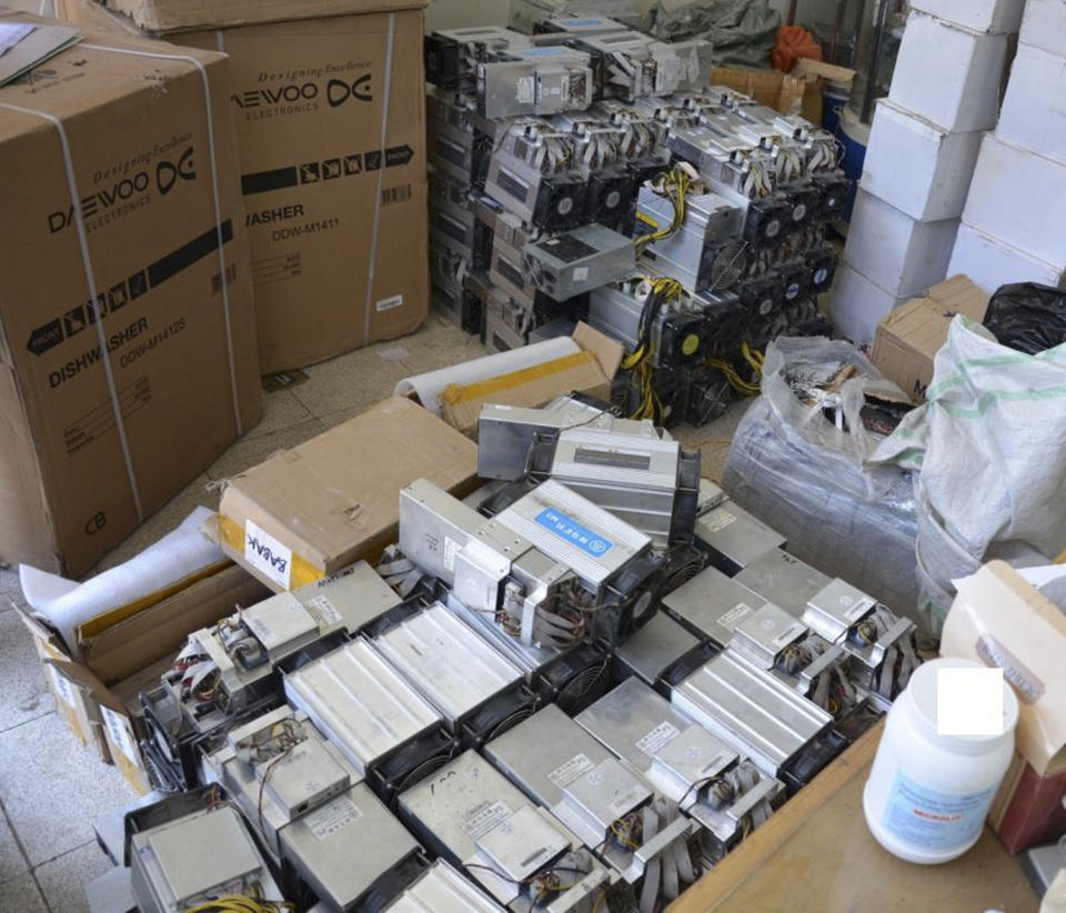 This undated photo provided by the Police News Agency, shows boxes of machinery used in Bitcoin "mining" operations that were confiscated by police in Nazarabad, Iran. Squeezed by sanctions and fueled by subsidized electricity, Iranians and others lured to the country increasingly are turning to Bitcoin and other digital cryptocurrencies. Some mine for the currency. That involves harnessing the power of their computers to verify and secure other users’ transactions around the world so that the same bitcoin isn’t spent twice. They are given new bitcoins as rewards. (News.police.ir via AP)