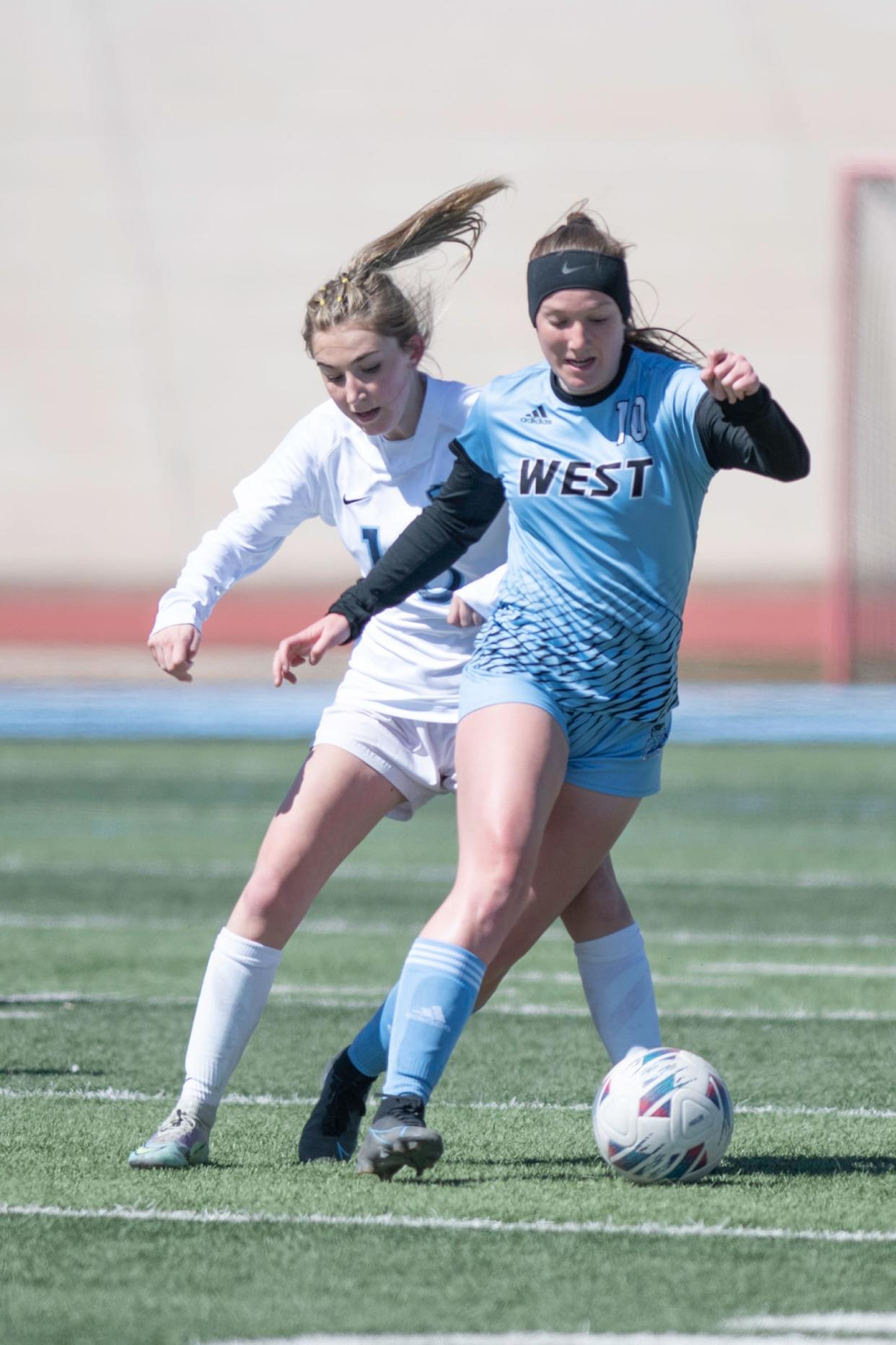 Pueblo West's Kaitlyn Peterson outraces a Riverdale Ridge defender during a matchup at Cyclone Stadium on Saturday, March 25, 2023.