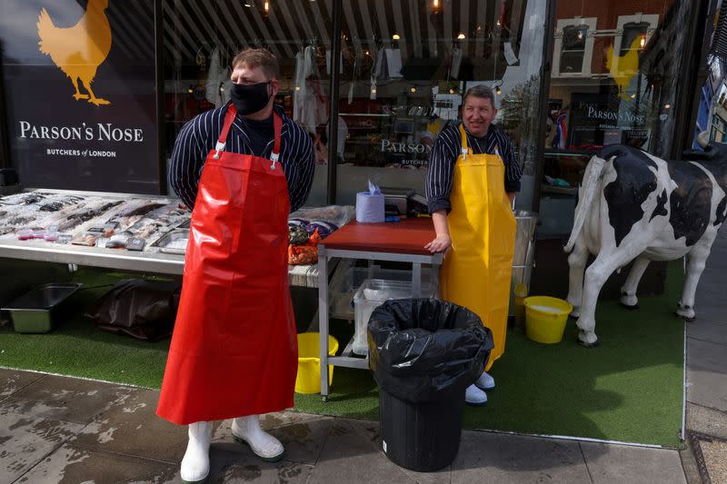 Fishmongers John Arkle and Paul Greenslade work at a fish stall