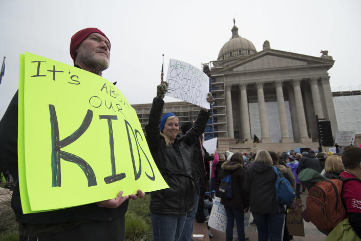 <p>Kent Scott, a teacher from Tecumseh, Okla., holds a protest sign at the state Capitol on April 2, 2018, in Oklahoma City. (Photo: J Pat Carter/Getty Images) </p>