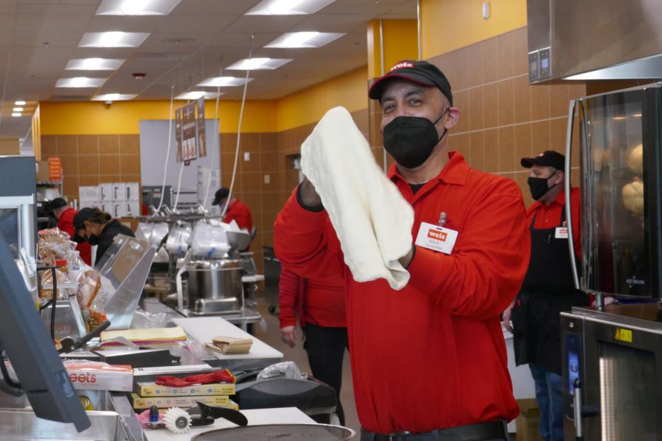 Weis Deli Manager Jesus Valentin throws dough for a pizza at the new Weis supermarket that opened on York Road in Warminster in January.