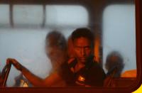 RNPS - PICTURES OF THE YEAR 2013 - Mohammed Ilmi Adam, a 17-year-old Somali would-be immigrant, looks out of a window on a police bus after arriving at the Armed Forces of Malta (AFM) Maritime Squadron base at Haywharf in Valletta's Marsamxett Harbour early July 10, 2013. Sixty-eight African immigrants were rescued by the AFM, 70 nautical miles (130 km) south of Malta from a vessel in distress while trying to reach European soil from Africa, according to army sources. REUTERS/Darrin Zammit Lupi (MALTA - Tags: TPXY SOCIETY IMMIGRATION POLITICS TRANSPORT) MALTA OUT. NO COMMERCIAL OR EDITORIAL SALES IN MALTA