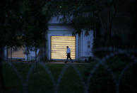 A Turkish police officer walks inside the property of the residence of the Saudi consul General Mohammed al-Otaibi as Turkish police conducted a search after the disappearance and alleged slaying of writer Jamal Khashoggi, in Istanbul, Wednesday, Oct. 17, 2018. A pro-government Turkish newspaper on Wednesday published a gruesome recounting of the alleged slaying of Saudi writer Khashoggi at the Saudi Consulate in Istanbul, just as America's top diplomat arrived in the country for talks over the Washington Post columnist's disappearance. (AP Photo/Emrah Gurel)