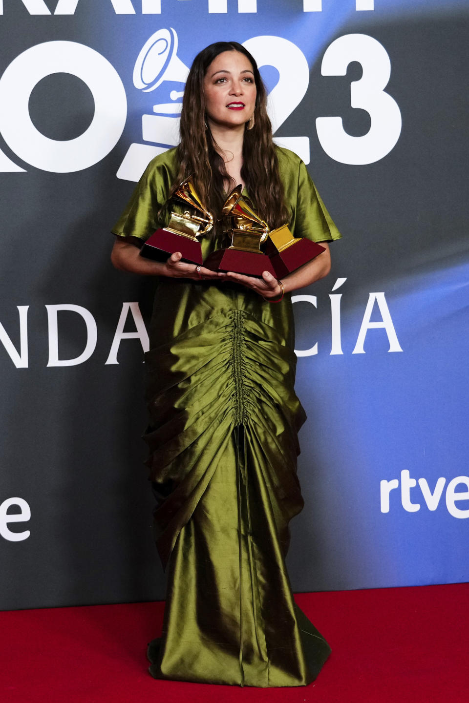 Natalia Lafourcade poses in the press room with the awards for record of the year, best singer-songwriter song, and best singer-songwriter album for "De Todas Las Flores" during the 24th annual Latin Grammy Awards in Seville, Spain, Thursday, Nov. 16, 2023. (Photo by Jose Breton/Invision/AP)