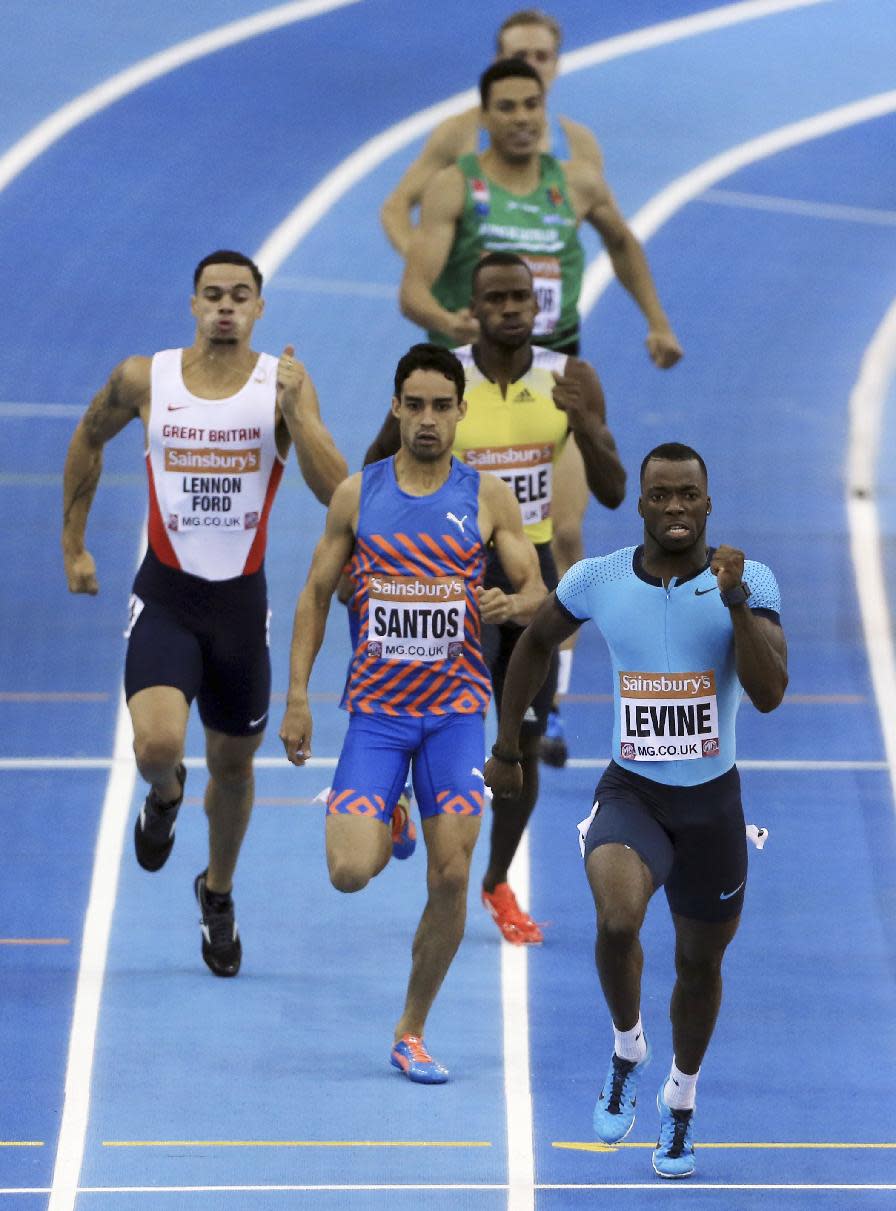 Great Britain's Nigel Levine on his way to victory in the 400 metres men's Final, during the British Athletics Indoor Grand Prix at the National Indoor Arena, Birmingham. England, Saturday Feb. 15, 2014. Luguelin Santos of Dominica, centre, Luke Lennon-Ford of Great Britain, left. (AP Photo / Nick Potts, PA) UNITED KINGDOM OUT - NO SALES - NO ARCHIVES