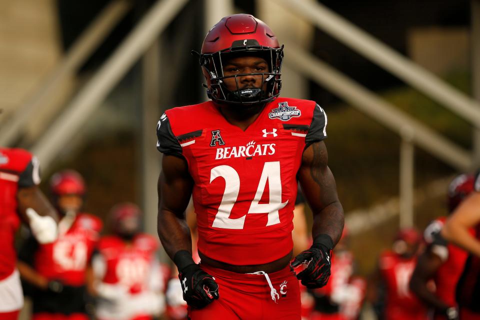 Cincinnati Bearcats running back Jerome Ford (24) and the Bearcats take the field in the first quarter of the American Athletic Conference Championship football game between the Cincinnati Bearcats and the Houston Cougars at Nippert Stadium in Cincinnati on Saturday, Dec. 4, 2021. The Bearcats led 14-13 at the half. 