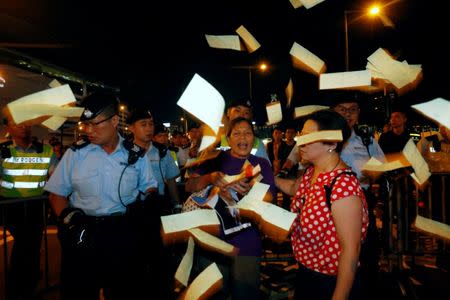 A protester throws mock paper money, three days before the 20th anniversary of the territory's handover to Chinese rule, in Hong Kong, China June 28, 2017. REUTERS/Bobby Yip