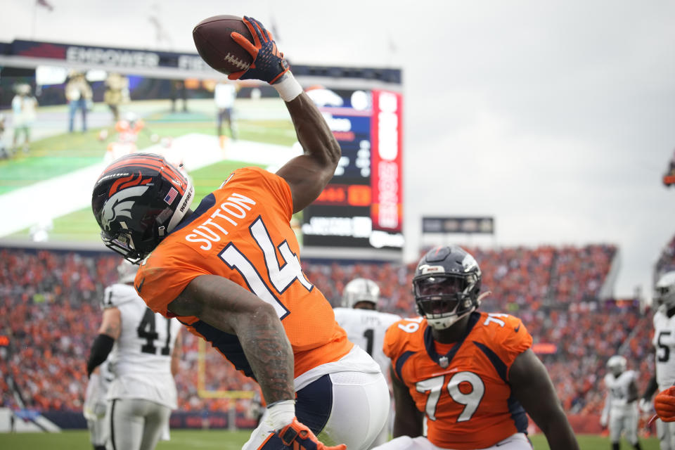 Denver Broncos wide receiver Courtland Sutton (14) celebrates his touchdown catch against the Las Vegas Raiders with Broncos center Lloyd Cushenberry III (79) during the first half of an NFL football game, Sunday, Sept. 10, 2023, in Denver. (AP Photo/David Zalubowski)